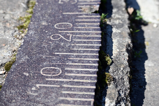 An old graduated scale for turning an artillery piece by degrees for firing.  A system of strokes is applied to the metal surface - degrees of rotation with Arabic numerals. Ivangorod Fortress, Russia