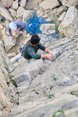 Top view of a man climbing a rock wall.