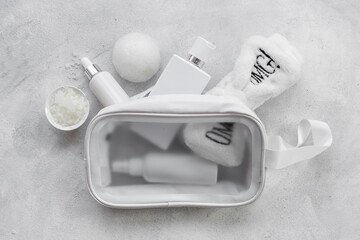 Cosmetic bag with white cosmetic products, top view