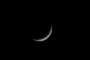 Fototapeta na wymiar new moon against black sky