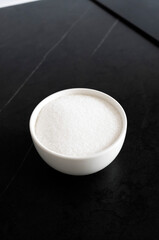 White sugar in a bowl on the kitchen table