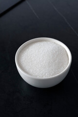 White sugar in a bowl on the kitchen table