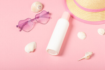 Obraz na płótnie Canvas Children's sunscreen, sunglasses accessories and jewelry on a pink background. Cosmetics and accessories for little girls, flat lay. Summer baby cosmetics