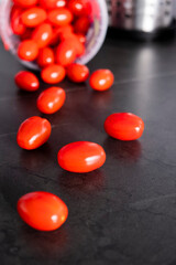 little tomatoes pouring out of a bucket