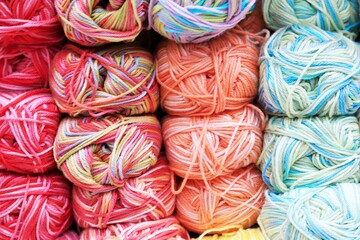 Balls of bright motley woolen yarn for needlework