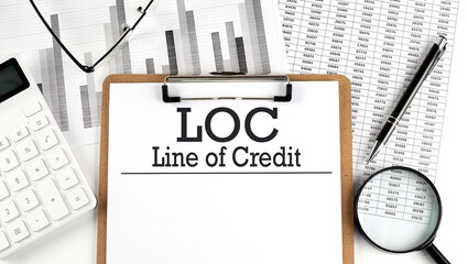 Paper with LOC - Line of Credit table on charts, business concept