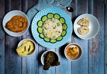 Assorted indian food decoration on the dark wooden background. Dishes and appetizers of indian cuisine.