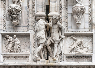 Marble sculpture depicting strong muscled telamons and other bas reliefs, detail on the façade of...