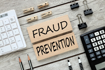 Fraud prevention . text on wooden blocks on wooden background