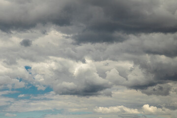Dramatic sky with grey and black clouds in a panoramic scenery 