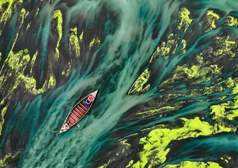 Wall murals Khaki Villagers boating through green water plants in Bangladeshi rivers