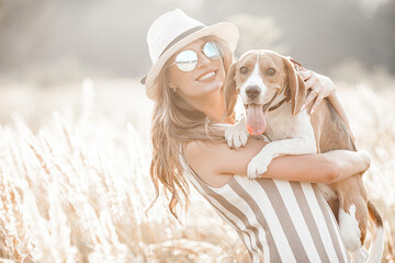Attractiive young woman outdoors with her pet. Owner and dog together. Friends forever. Lady and...