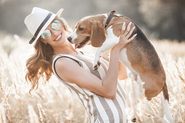 Attractiive young woman outdoors with her pet. Owner and dog together. Friends forever. Lady and...