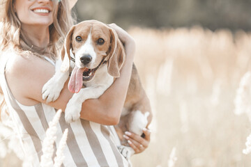 Attractiive young woman outdoors with her pet. Owner and dog together. Friends forever. Lady and...
