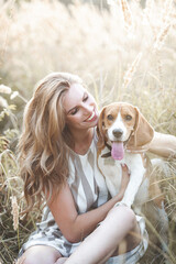 Attractiive young woman outdoors with her pet. Owner and dog together. Friends forever. Lady and...