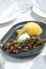 Fried meat with porridge on a plate, Ukrainian cuisine. Photo of food on a white background