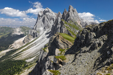 A rocky ravine leading to the Seceda Plateau, with the Odle mountain range in the background