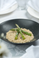 Porridge with asparagus on a plate, Ukrainian cuisine. Photo of food on a white background