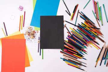 drawing workstation with colored pencils and paper