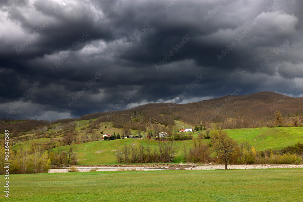 Poster summer stormy alpine mountain landscape with low clouds, province of genoa, ligurian alps, italy, eu