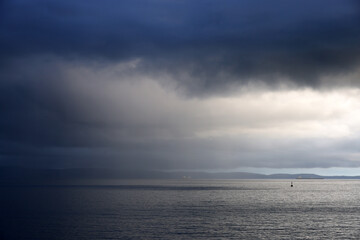 Obraz premium Cloudy storm in the sea before rainy. Tornado storms cloud above the sea. Monsoon season. Huge storm clouds with rain over sea , Strong winds, heavy rain storm.