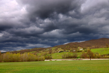 Fototapeta premium Summer stormy alpine mountain landscape with low clouds, province of Genoa, Ligurian Alps, Italy, Europe