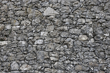 Rock texture. Stone background. Old weathered crumbling mountain surface in cracks background. Light brown rock background