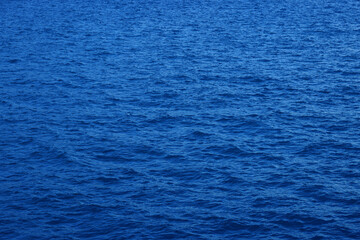 Blue water background. Ripple sea ocean water surface. still calm sea ocean water surface. close up blue water surface at deep ocean. Light blue background