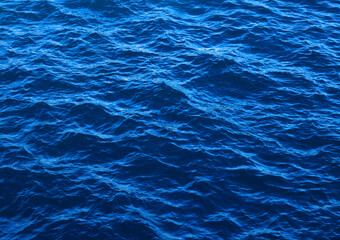Dark blue wavy sea water background. Water surface, natural abstract background.