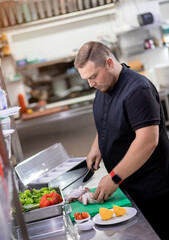 The chef cuts the chicken carcass and prepares it for marinating