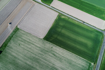 zenithal drone view of two tractors in crop fields