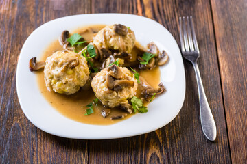 meat and potato balls in mushroom sauce