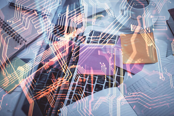 Technology hologram drawing over computer on the desktop background. Top view. Double exposure. Tech concept.