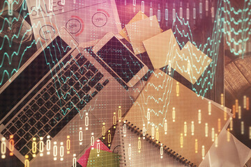 Financial market graph and top view computer on the desktop background. Multi exposure. Investment concept.