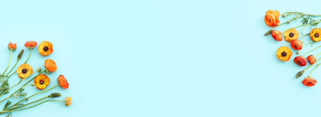 Top view image of yellow flowers composition over blue background