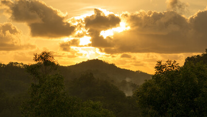 The beautiful sunset on the hill is golden yellow