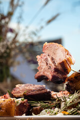 Grilled pork ribs with rosemary and sauces.  Pork ribs BBQ.  The large plate of meat.  Roast pork