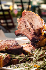 Grilled pork ribs with rosemary and sauces.  Pork ribs BBQ.  The large plate of meat.  Roast pork