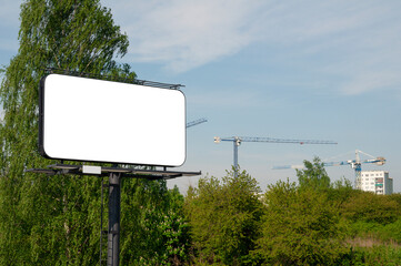 Blank white billboard for advertisement in front of the construction site near city park