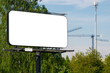 Blank white billboard for advertisement in front of the construction site near city park