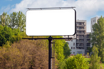 Blank white billboard for advertisement in the front of apartment building near city park