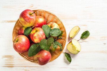 Apples. Fresh ripe red apples in the basket at white table. Top view.