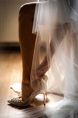 bride holds wedding bridal shoes
