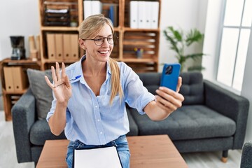 Beautiful woman doing online therapy session at consultation office looking positive and happy...