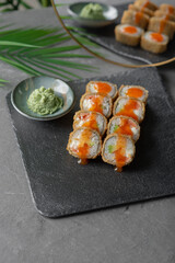 Hot tempura sushi on a gray dish close-up