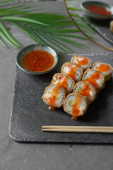 Hot tempura sushi on a gray dish close-up