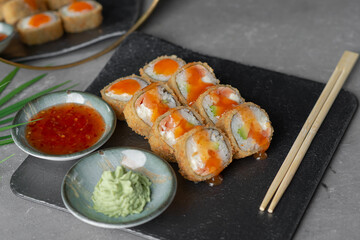 Hot tempura sushi on a gray dish close-up