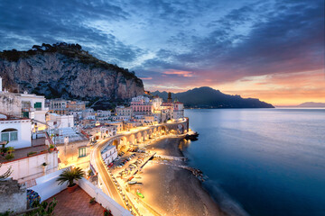 The village of Atrani, right next to Amalfi during sunrise with a beautiful sky and lights in the...