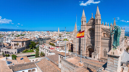 Aerial view of the Spanish flag near the La Seu, the gothic medieval cathedral of Palma de Mallorca in Spain
