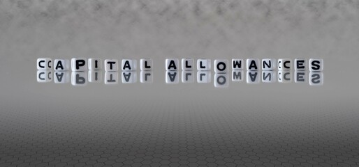 capital allowances word or concept represented by black and white letter cubes on a grey horizon background stretching to infinity